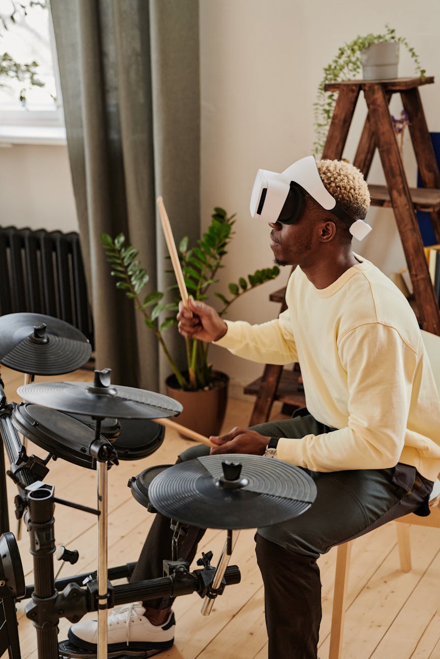 man wearing headset while playing drum kit