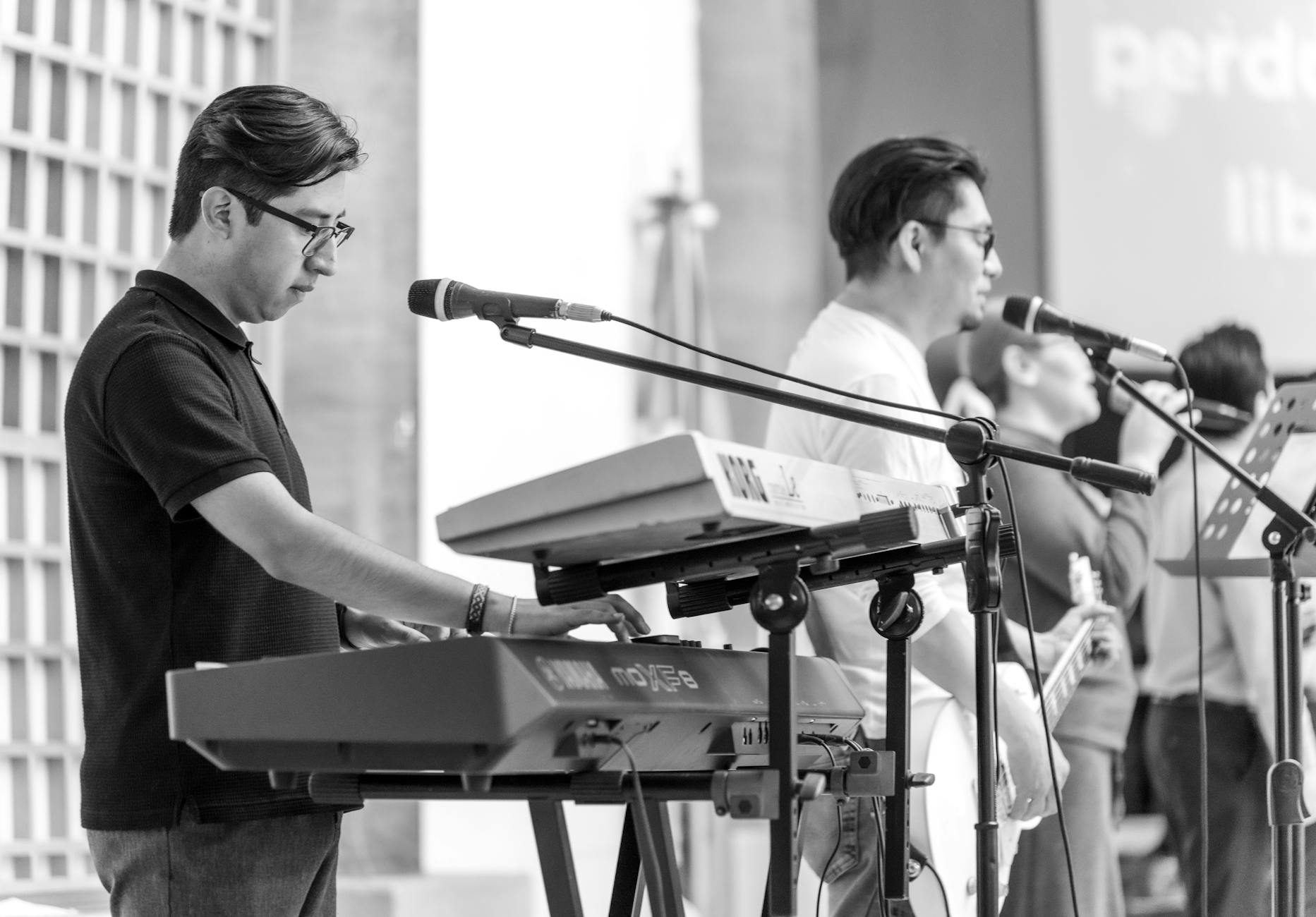 men playing keyboards at event