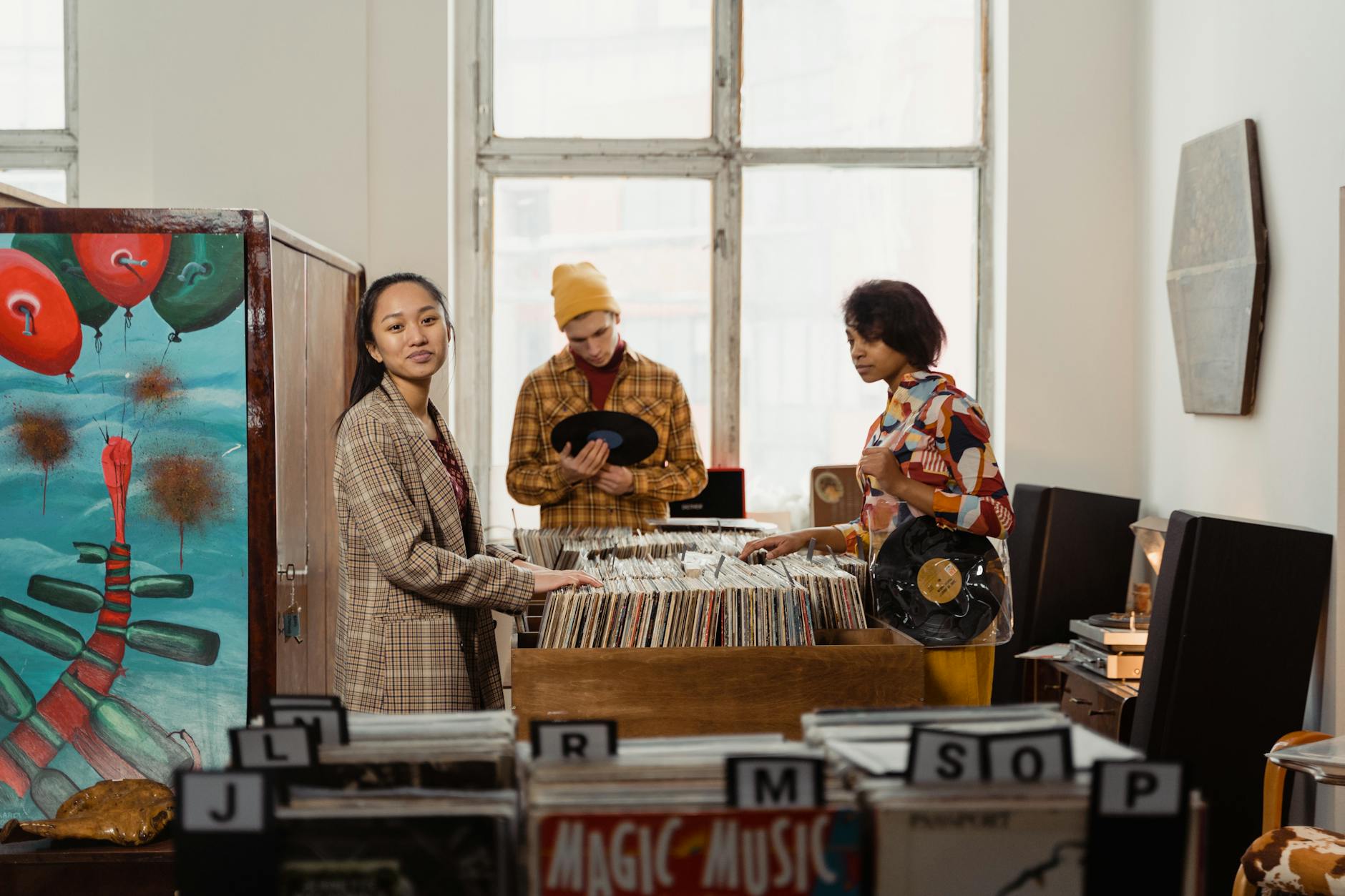 a group of people looking at vintage vinyl records